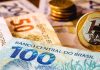 Real brasileño sube 4.5% frente al dólar tras primera vuelta entre Flávio Bolsonaro y Lula da Silva